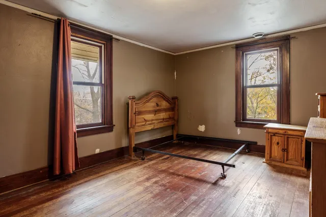 a room with lounge chair and windows