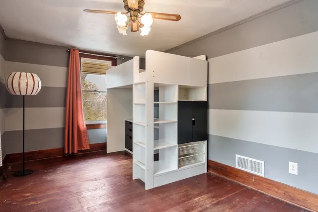 a view of an empty room with a closet