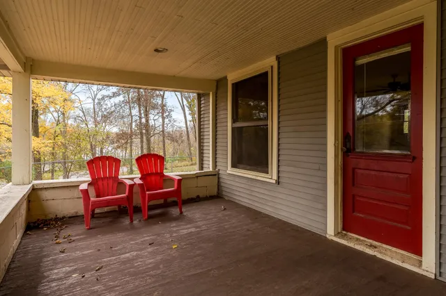 a living room with furniture and large windows