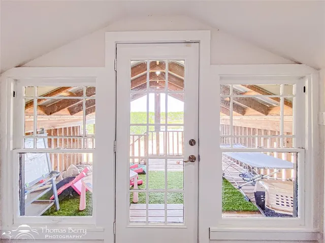 a bedroom with a bed a wooden floor and ceiling fan