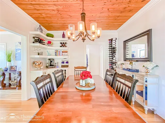a living room with furniture a fireplace and a dining table