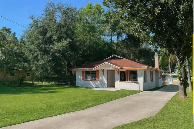 a front view of a house with a yard table and chairs