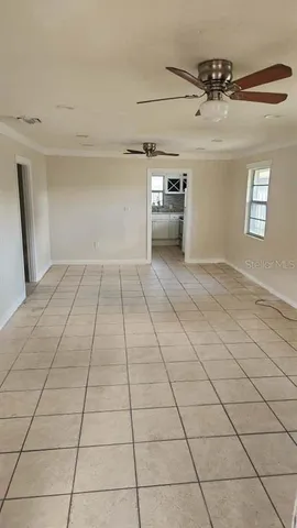 a view of a livingroom with a dishwasher and a refrigerator in a kitchen