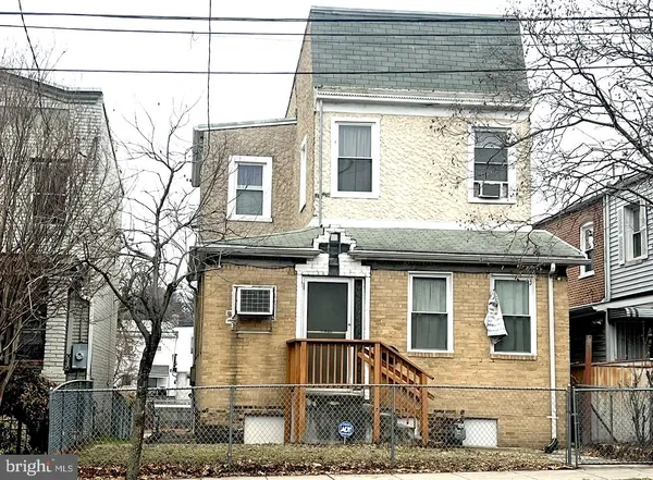 a view of a brick house with large windows