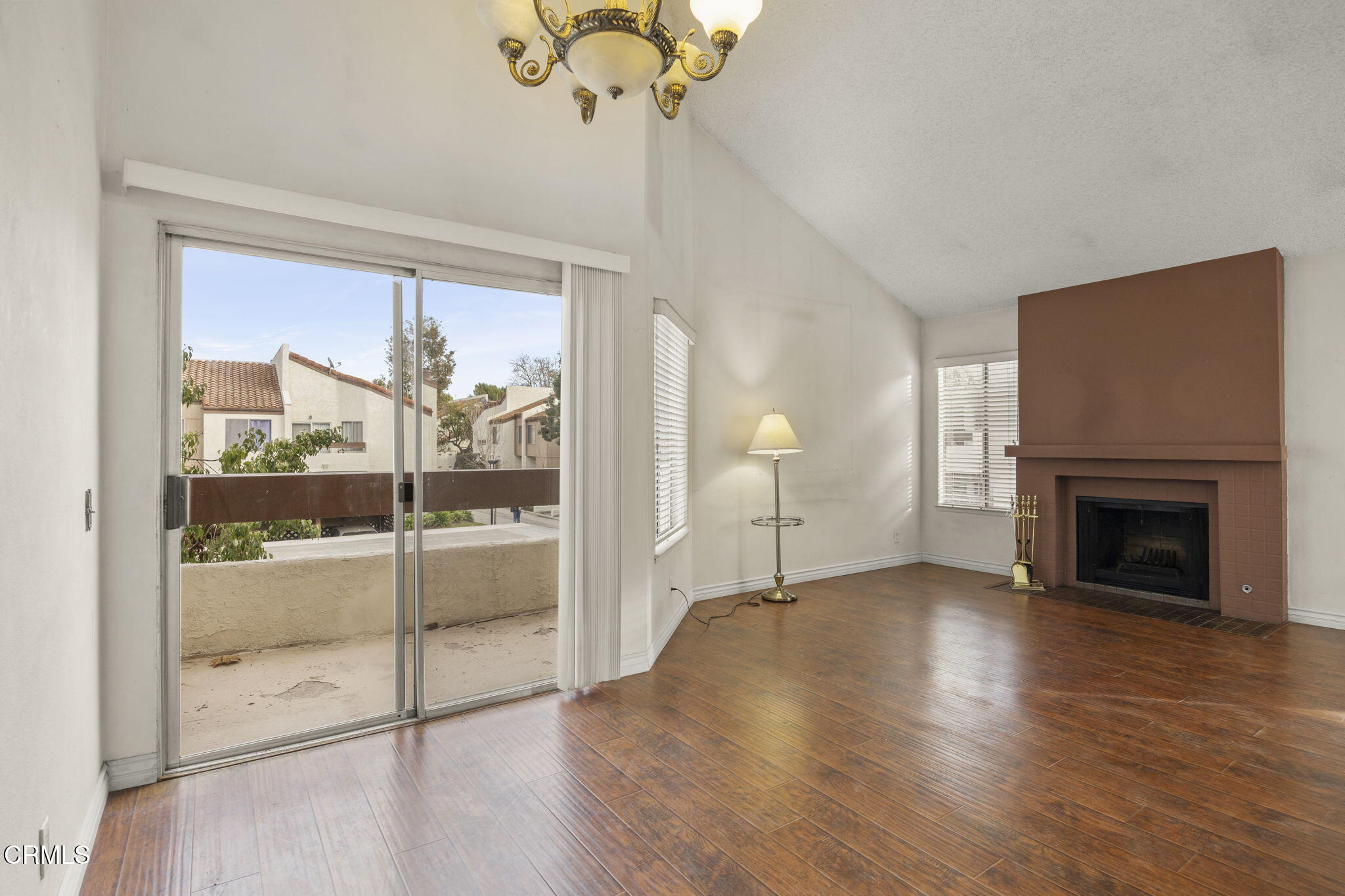 1718 Sinaloa Road, Unit 215 Simi Valley, CA 93065 - Photo 9 of 32 a view of a livingroom with a fireplace wooden floor and windows