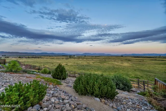 a view of a pathway with a garden