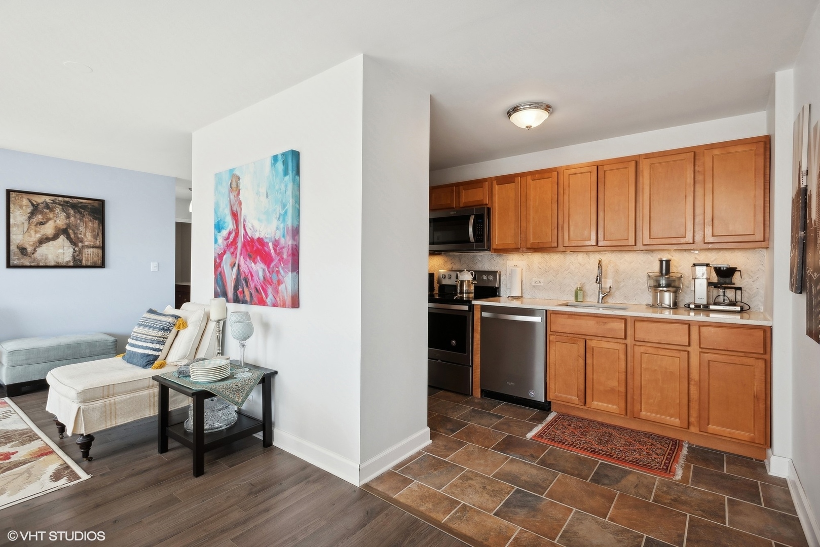 5701 North Sheridan Road, Unit 4Q Chicago, IL 60660 - Photo 9 of 23 a kitchen with a refrigerator cabinets and wooden floor