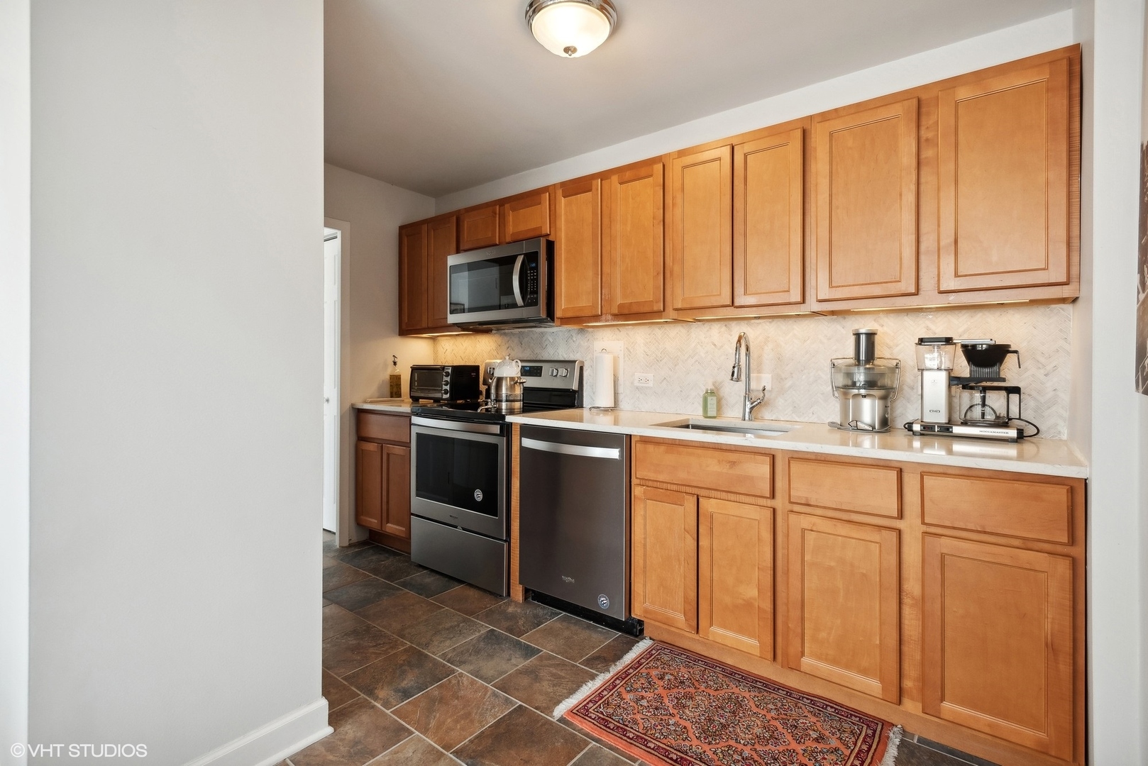 5701 North Sheridan Road, Unit 4Q Chicago, IL 60660 - Photo 10 of 23 a kitchen with stainless steel appliances granite countertop a refrigerator a stove a sink and a microwave