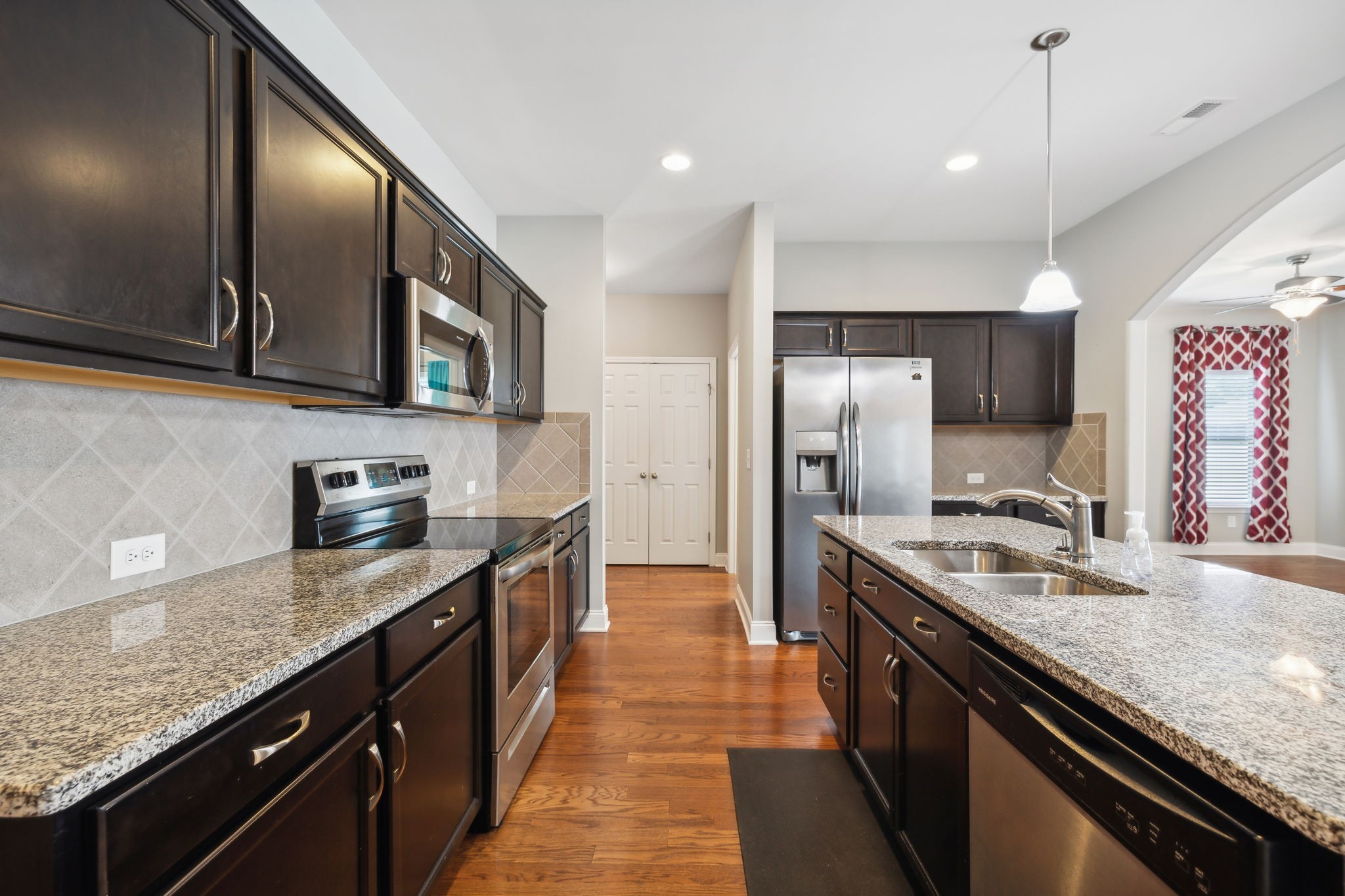 1229 Mayflower Way Lebanon, TN 37087 - Photo 12 of 42 a kitchen with stainless steel appliances granite countertop a sink stove and refrigerator