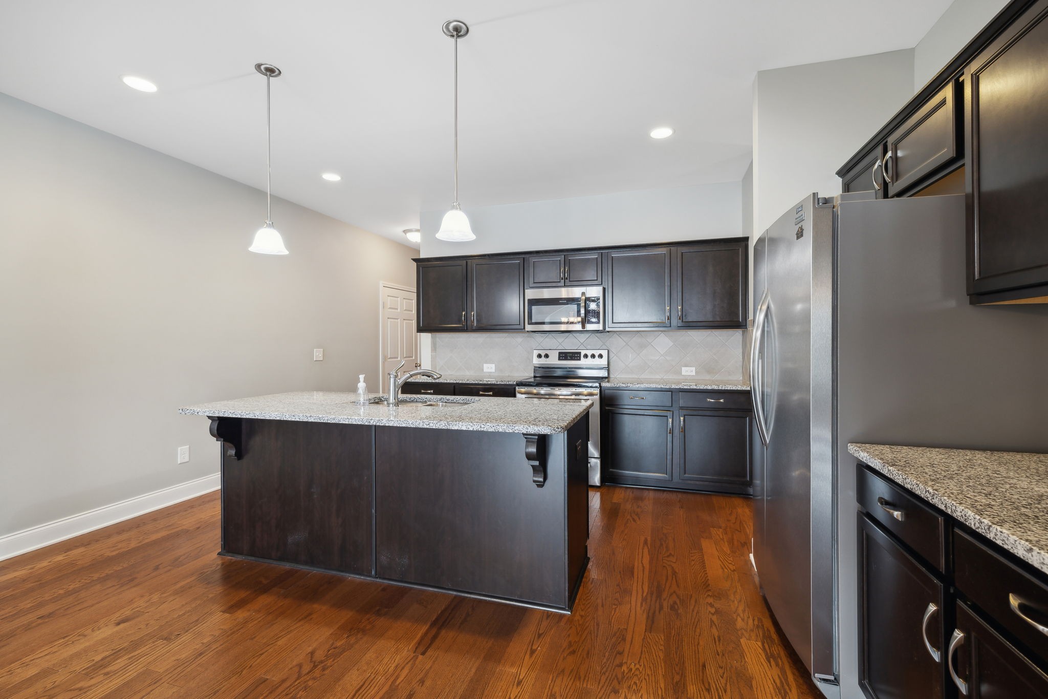 1229 Mayflower Way Lebanon, TN 37087 - Photo 15 of 42 a kitchen with stainless steel appliances granite countertop a sink a stove a refrigerator and island with wooden floor