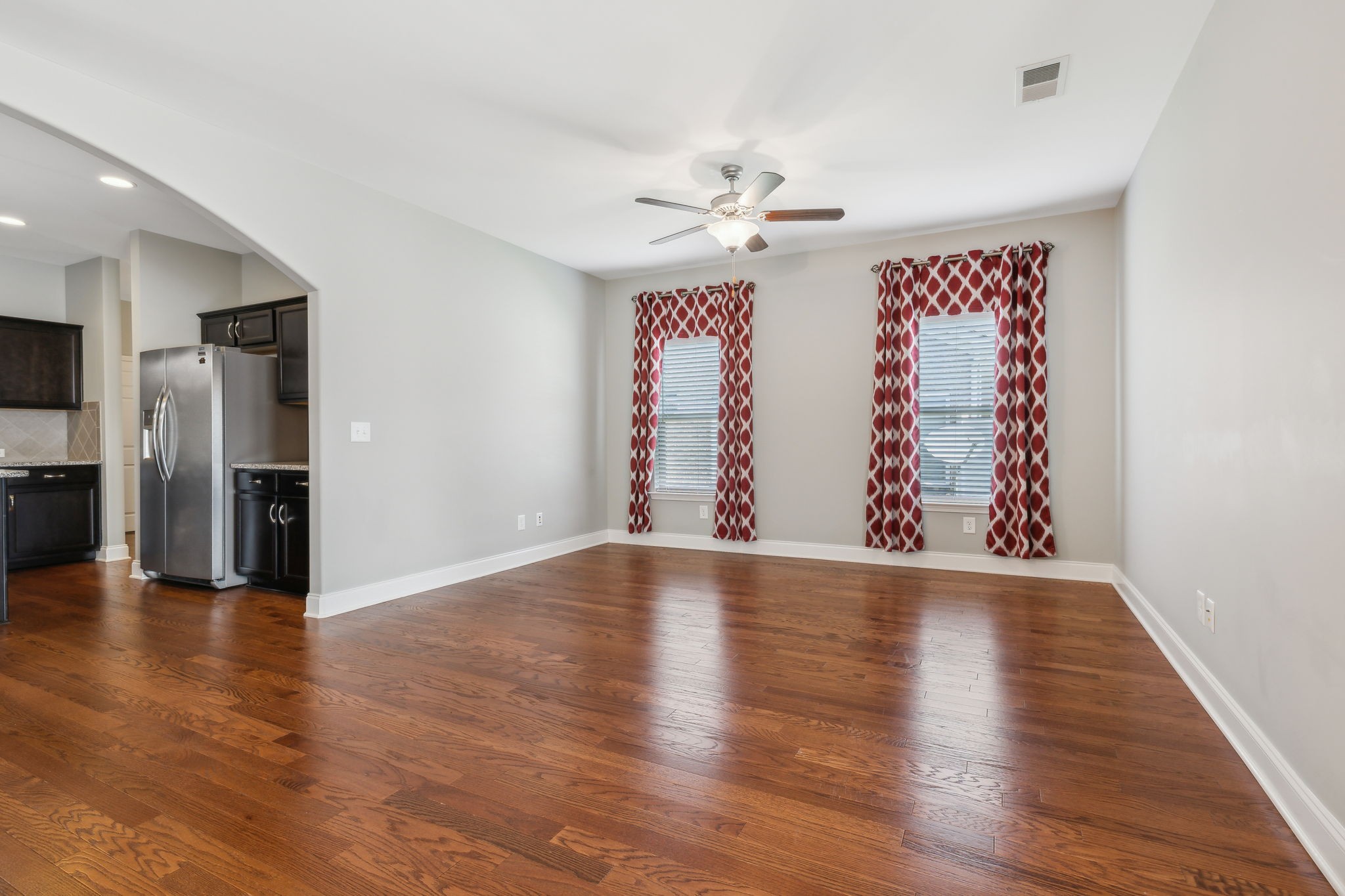 1229 Mayflower Way Lebanon, TN 37087 - Photo 18 of 42 a view of an empty room with wooden floor and a kitchen