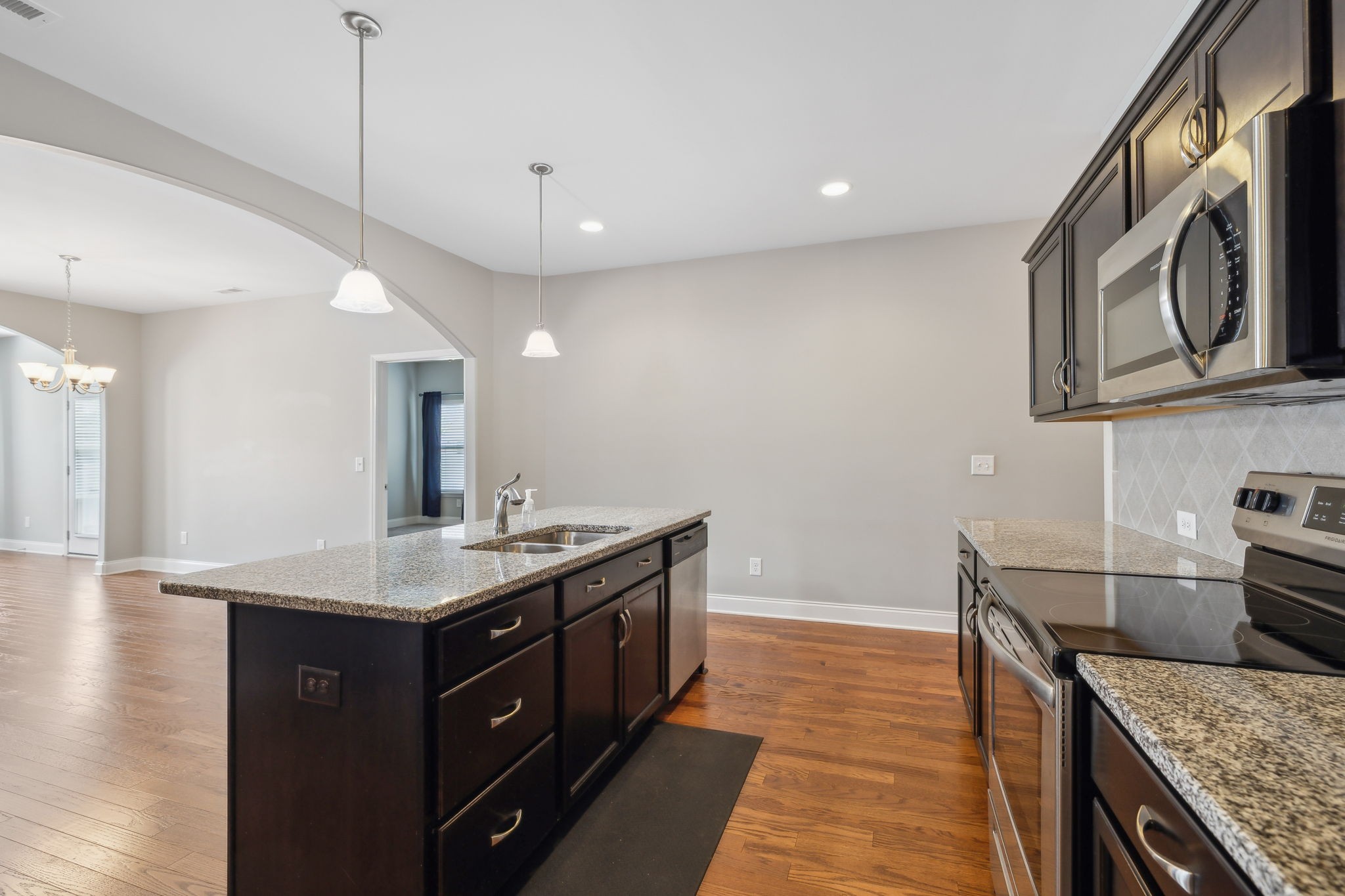 1229 Mayflower Way Lebanon, TN 37087 - Photo 10 of 42 a kitchen with a sink dishwasher and a stove with wooden floor