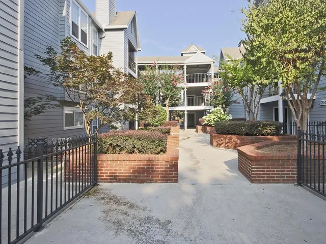 a view of a patio with couches and table and chairs and potted plants
