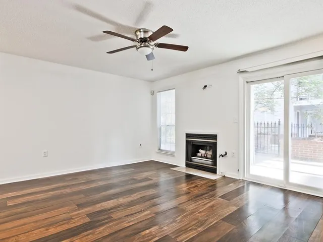 wooden floor in an empty room with a fireplace