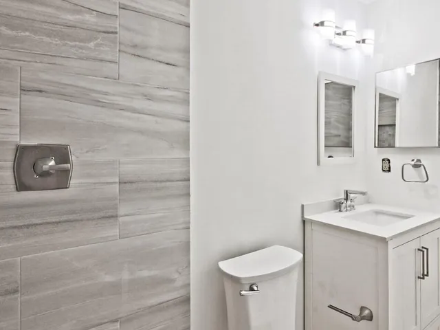 a bathroom with a sink toilet and vanity