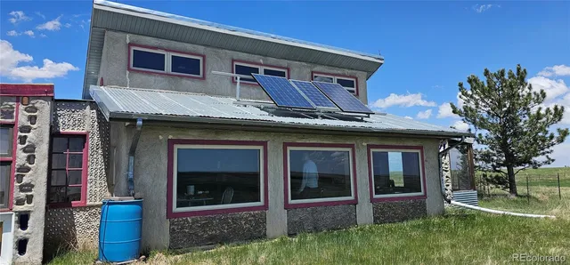 a house that has a tree in front of the house