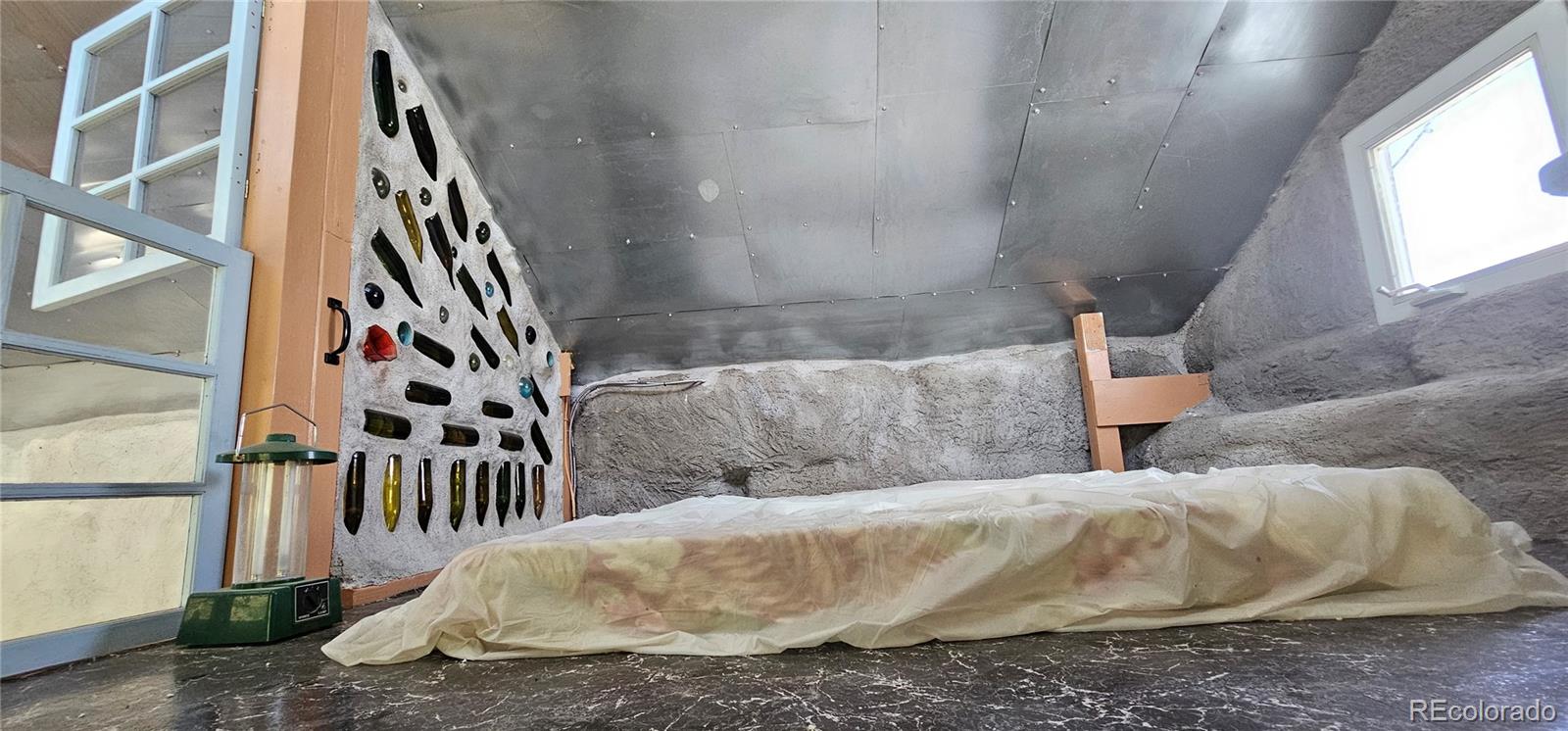 Wa County Road Cope, CO 80812 - Photo 24 of 48 a close up of a white bed in a white room