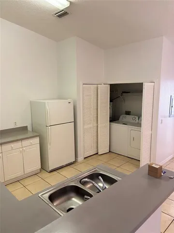 a kitchen with a refrigerator and a sink