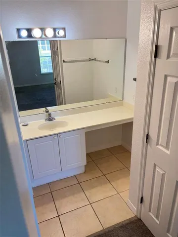 a bathroom with a sink a mirror and a shower