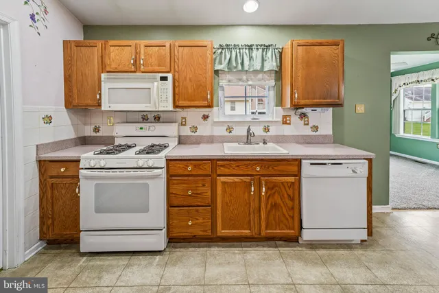 a kitchen with a stove sink and cabinets