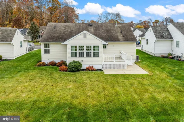 an aerial view of a house with a yard and lake view
