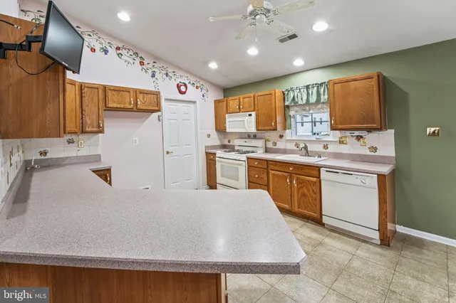 a kitchen with a sink window and cabinets