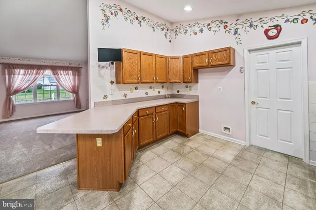 a kitchen with stainless steel appliances granite countertop a sink and a refrigerator