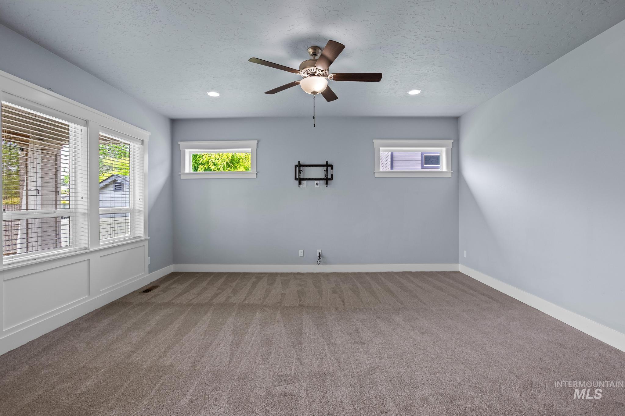 2681 East Rhyolite Court Nampa, ID 83686 - Photo 19 of 48 Spacious room with plush carpeting, recessed lighting, and a ceiling fan