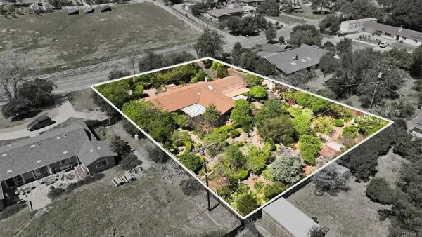 an aerial view of house with a yard