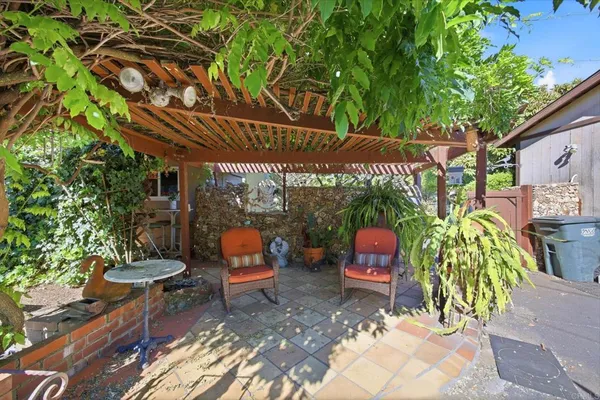 a view of a chairs and table in a patio