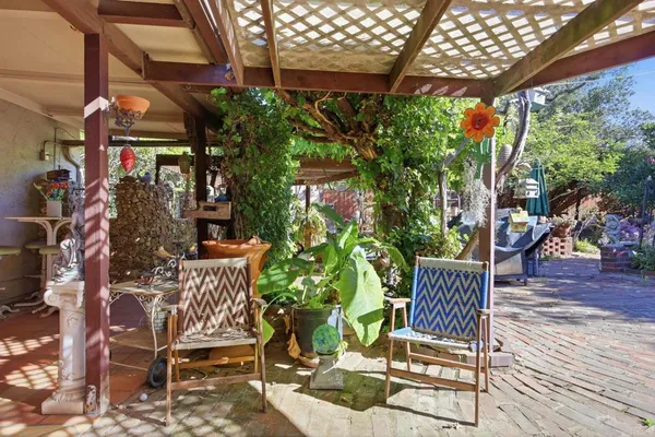 a view of a backyard with sitting area