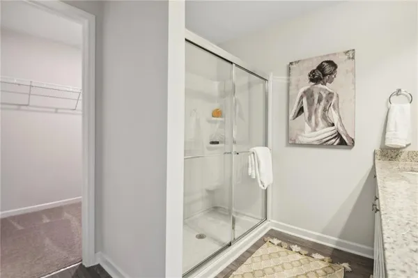 a bathroom with a glass shower door