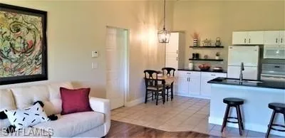a dining room with furniture and a kitchen view