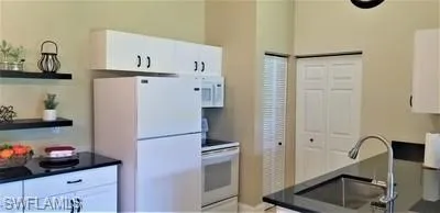 a kitchen with stainless steel appliances a refrigerator and a sink