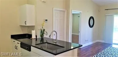a kitchen with stainless steel appliances granite countertop a sink a stove and a microwave