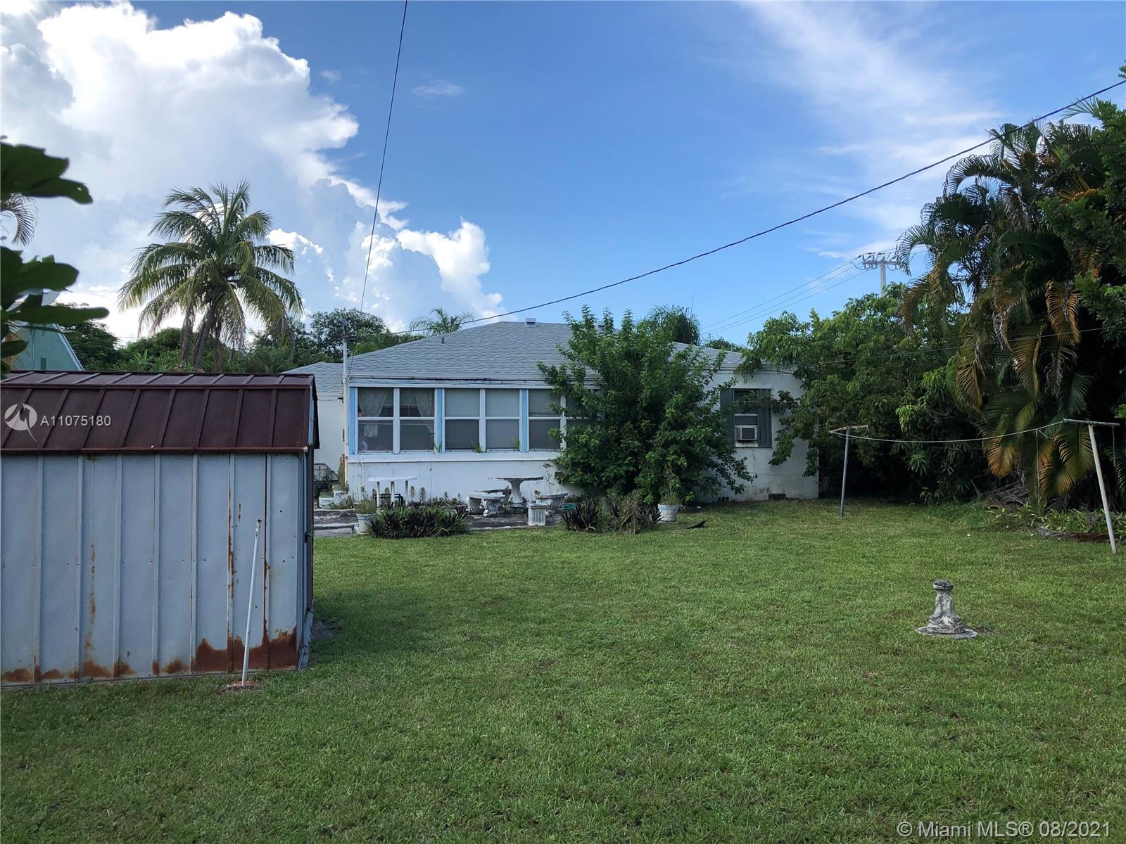 1504 Funston Street Hollywood, FL 33020 - Photo 2 of 10 a front view of a house with garden