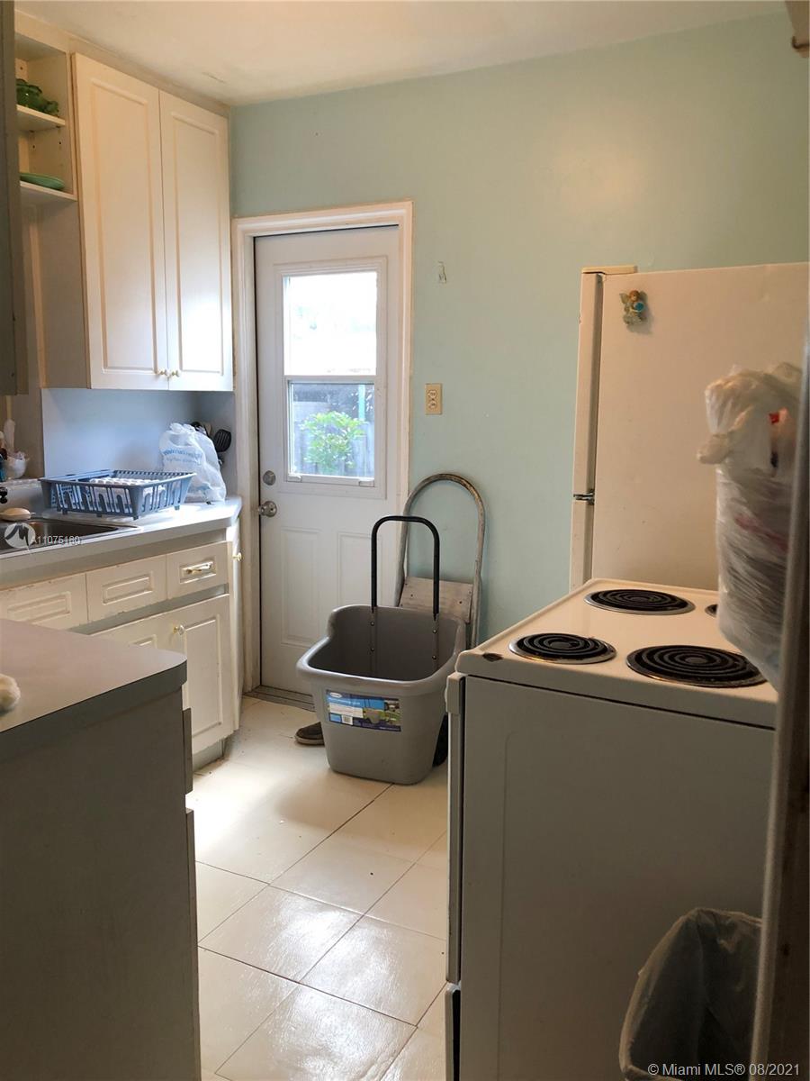 1504 Funston Street Hollywood, FL 33020 - Photo 5 of 10 a kitchen with a stove and a sink