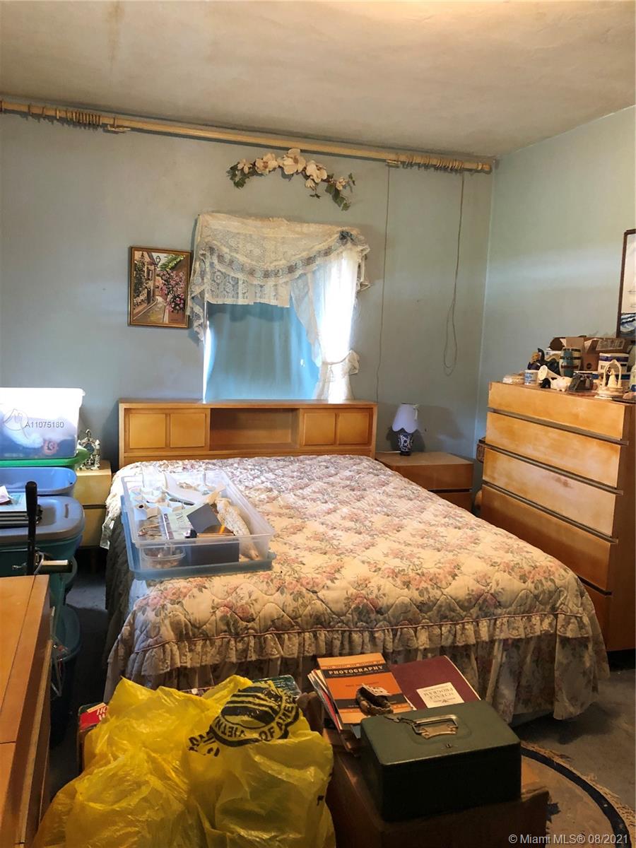 1504 Funston Street Hollywood, FL 33020 - Photo 8 of 10 a bedroom with a bed and window