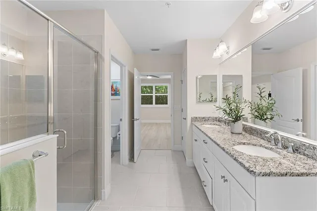 a bathroom with a granite countertop sink mirror and double