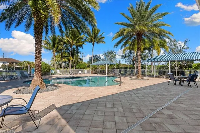a view of a swimming pool with a table and chairs