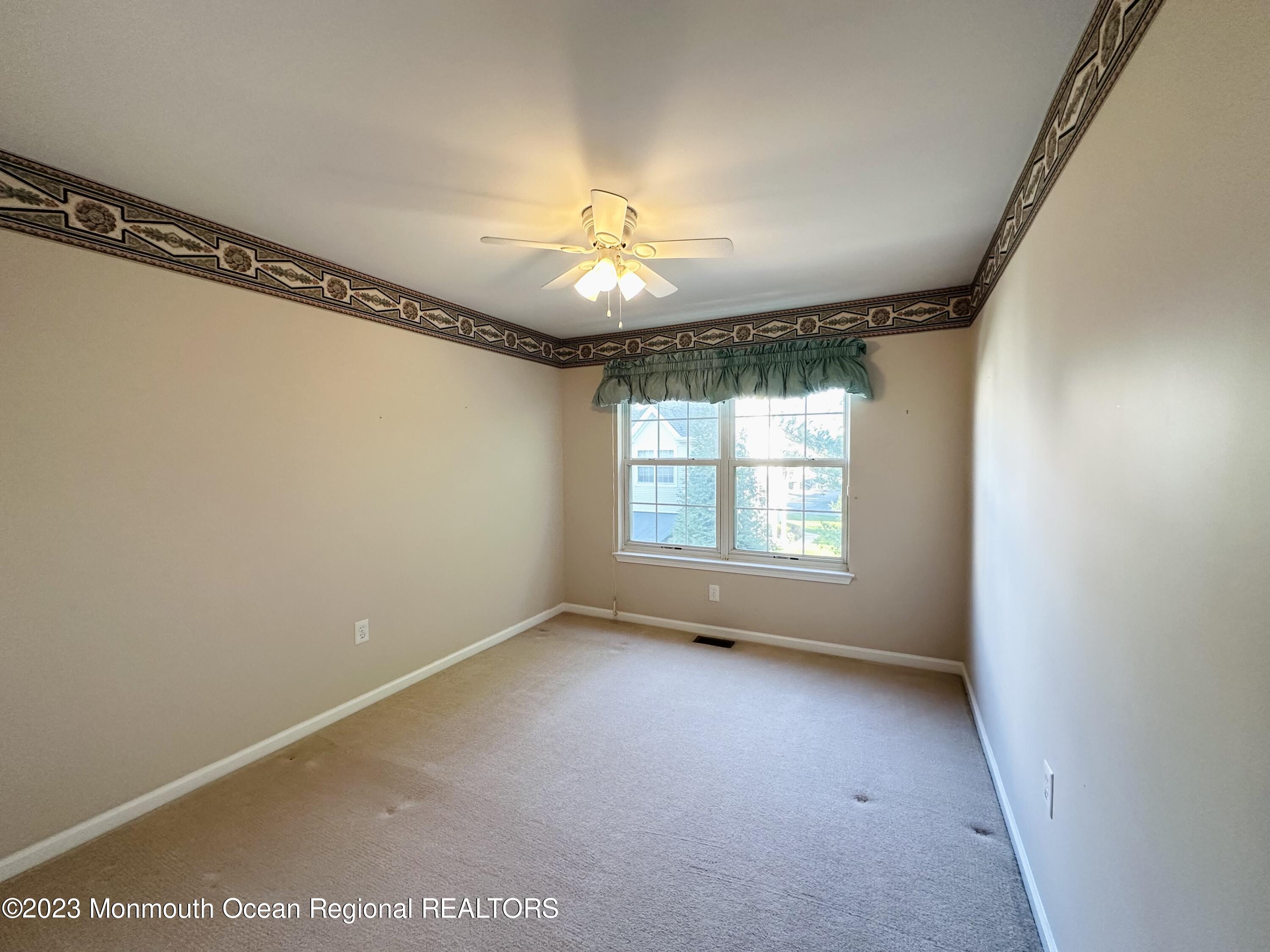 8 Alpine Road, Unit 197 Holmdel, NJ 07733 - Photo 12 of 18 a view of an empty room with a window