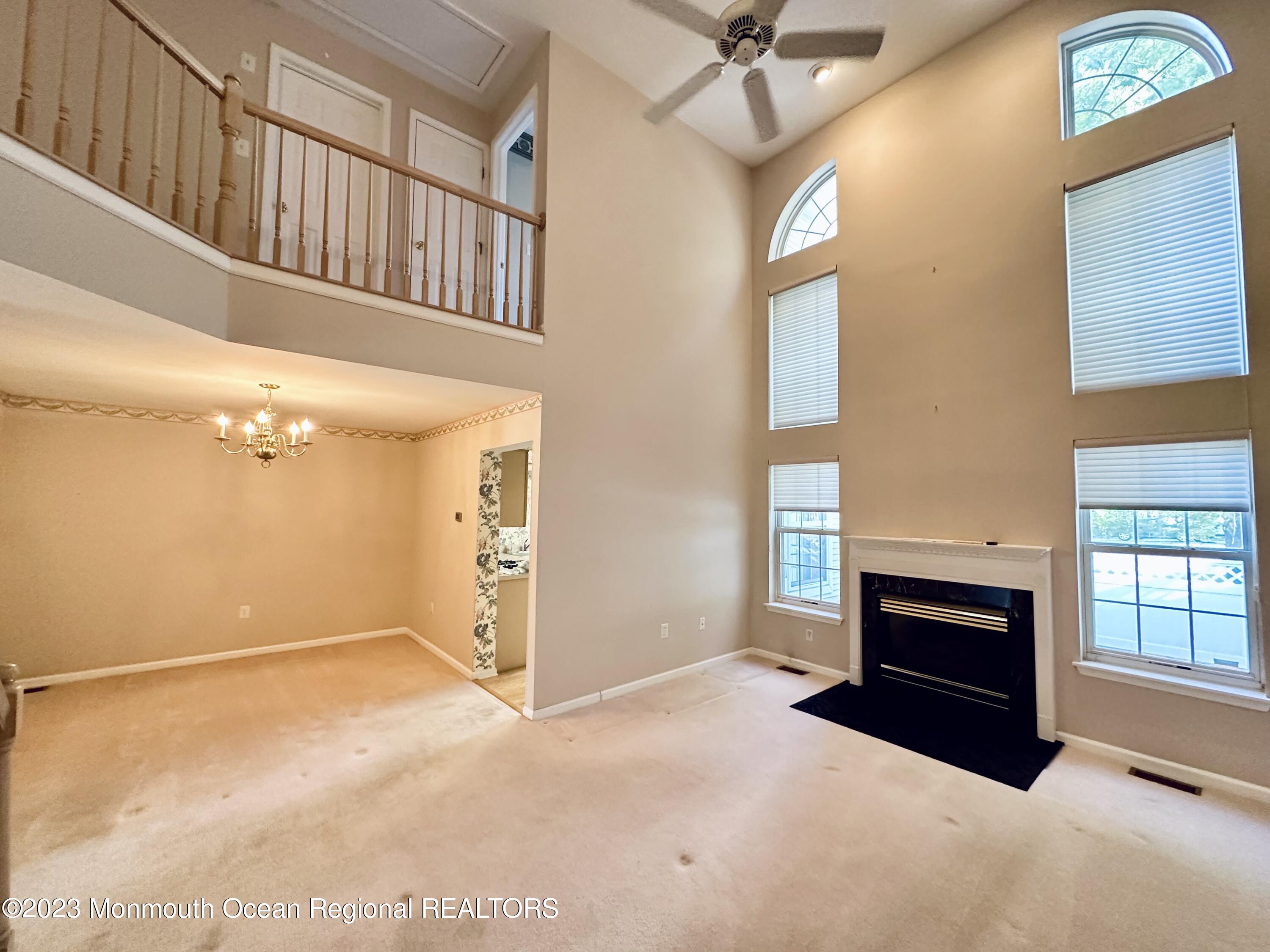 8 Alpine Road, Unit 197 Holmdel, NJ 07733 - Photo 5 of 18 a view of livingroom with furniture fireplace and windows
