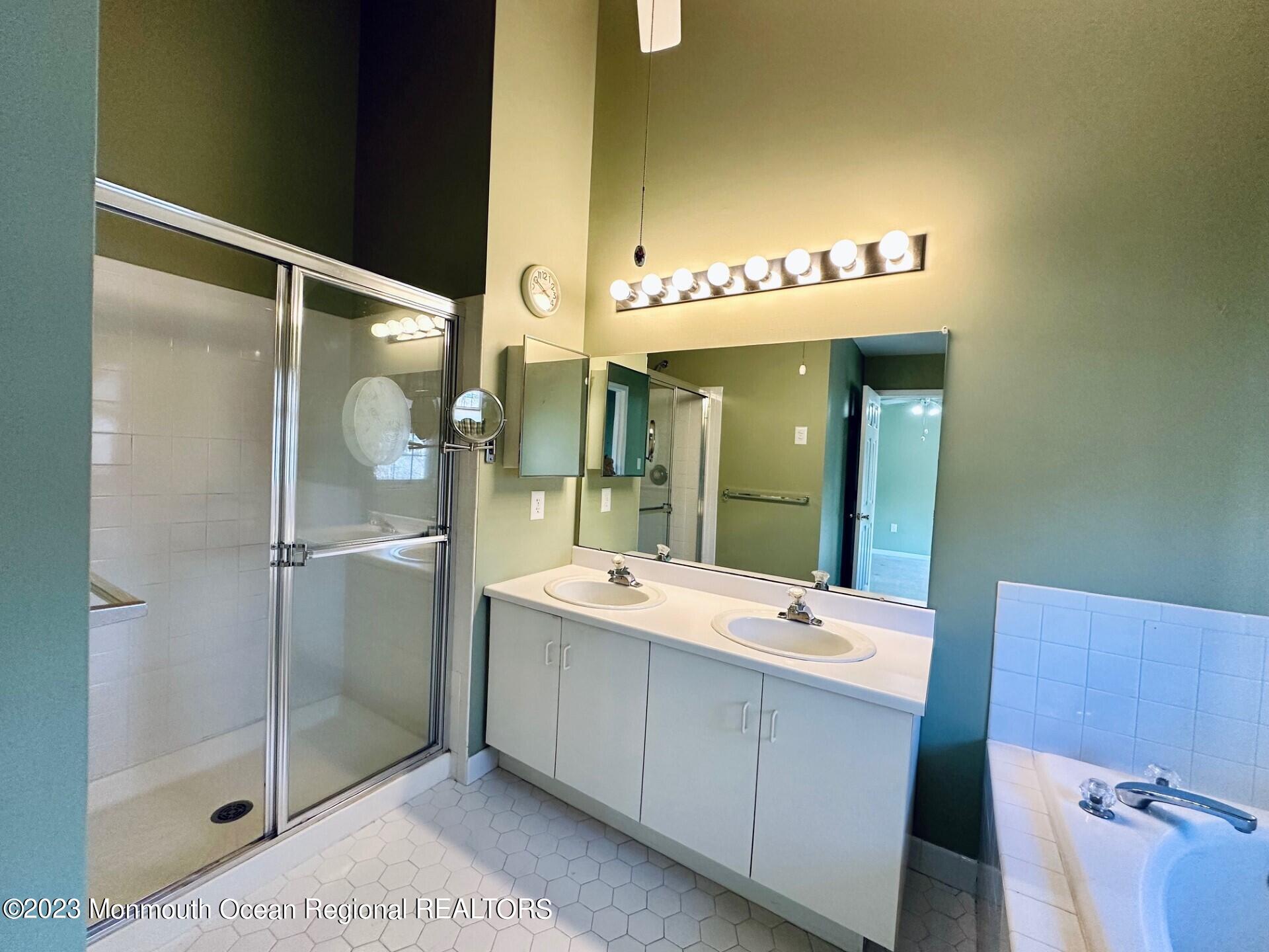 8 Alpine Road, Unit 197 Holmdel, NJ 07733 - Photo 10 of 18 a bathroom with a double vanity sink mirror and shower