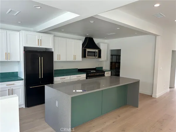 a kitchen with a refrigerator and a stove