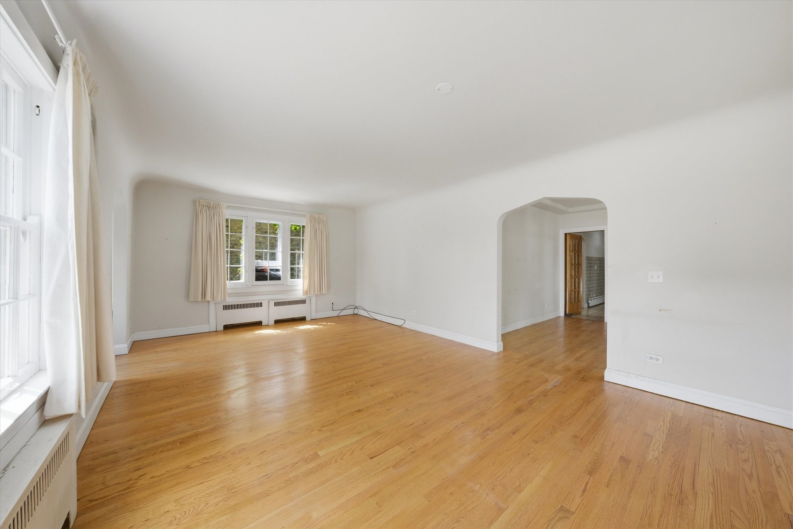 3100 Clinton Avenue Berwyn, IL 60402 - Photo 6 of 25 an empty room with wooden floor and windows