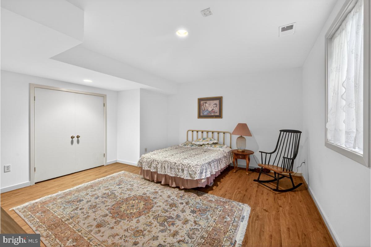 10320 Glen Road Potomac, MD 20854 - Photo 23 of 75 a view of a bedroom with furniture and wooden floor