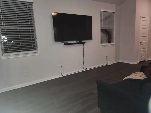 a living room with a flat screen tv and a fireplace