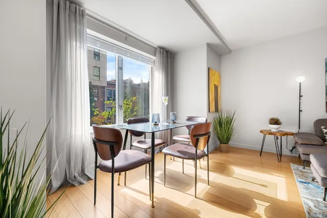 a view of a dining room with furniture and floor to ceiling windows
