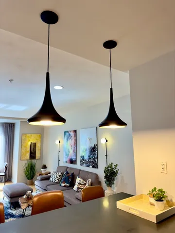 a living room with furniture and a chandelier
