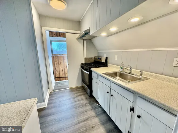 a kitchen with sink and cabinets